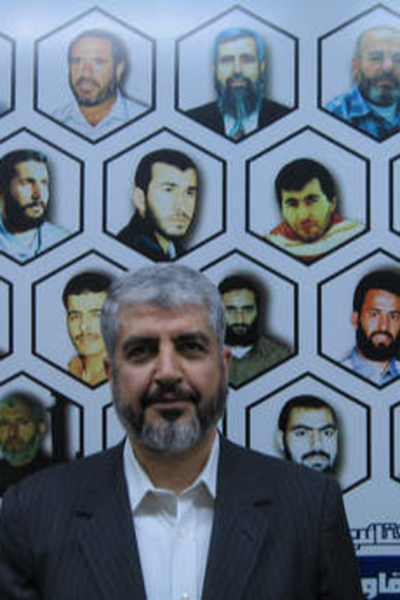 Mishal flanked by a mural of 20 Hamas leaders, fighters and bomb-makers who were killed in Israeli assassinations.