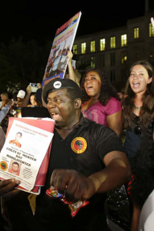 James Evan Muhammad, front left, of the New Black Panther Party, shouts slogans after the verdict was handed down at the Seminole County Courthouse.