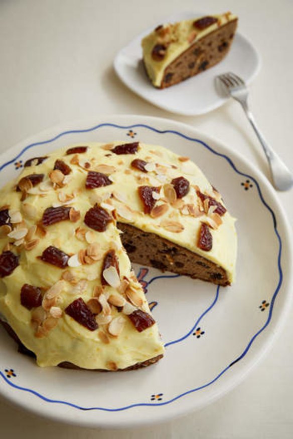Date and banana cake with orange icing.