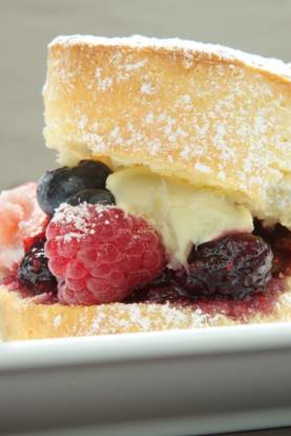 Scone with berries and clotted cream.