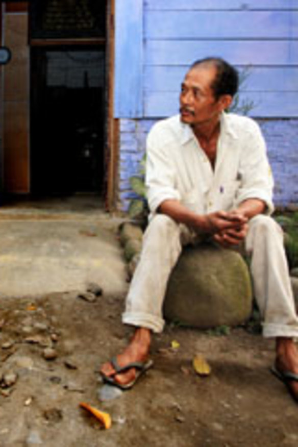 "People are angry with me" ... Aliaman with his co-worker Darwin outside Aliaman's house. Aliaman says his wife is also very angry and will not cook for him.