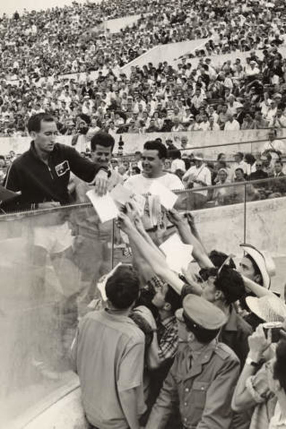 Running man: Elliott celebrates with fans after winning gold at the 1960 Rome Olympics.