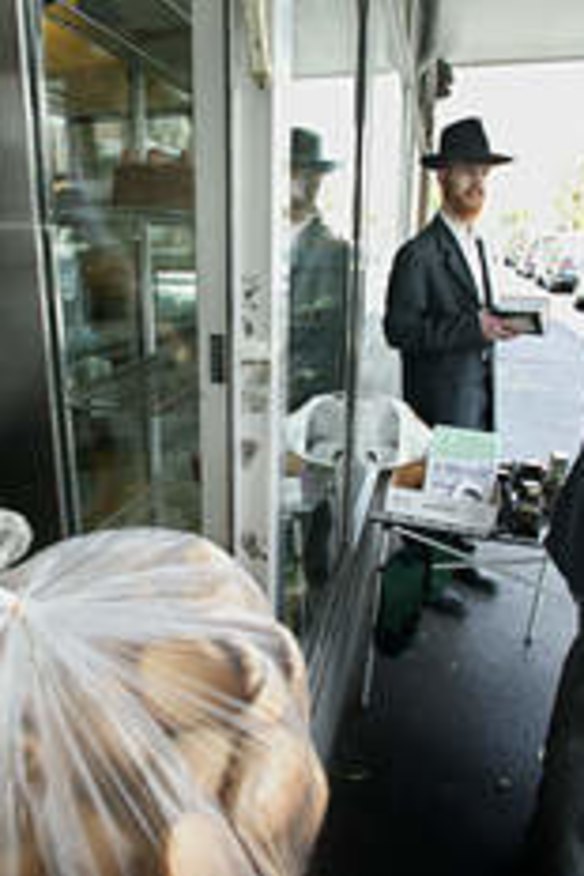 A member of the Jewish community buying Challah from Glick's.