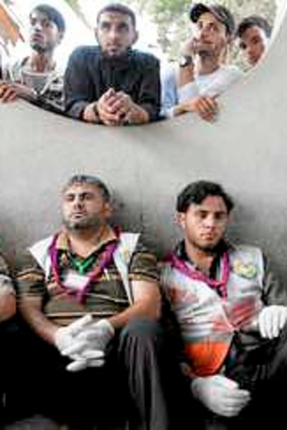 Exhausted Palestinian medics take a break at the hospital.