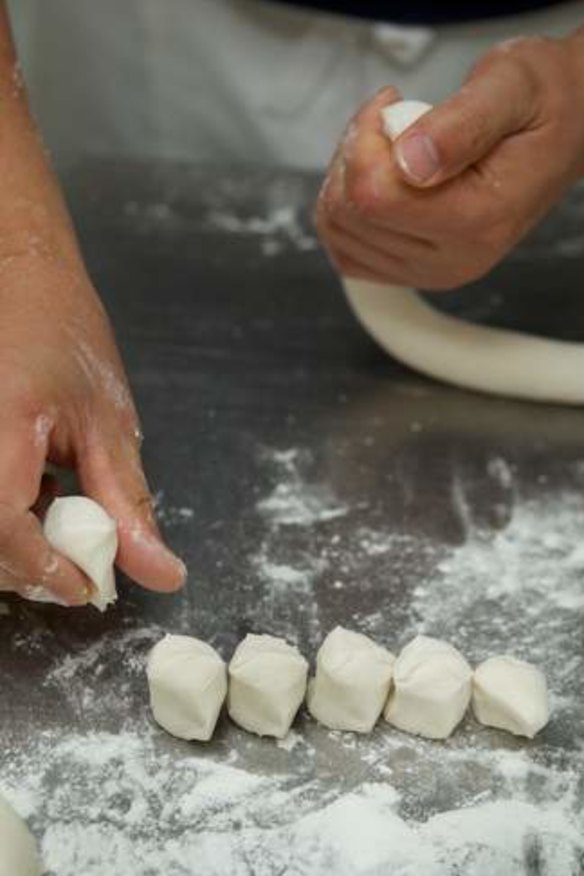 Sammy Shi, cutting the dumpling dough at Shanghai Street.