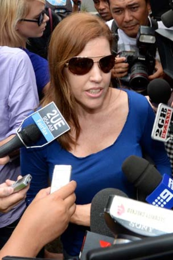 Schapelle's sister Mercedes fighting her way through the media pack after visiting her.