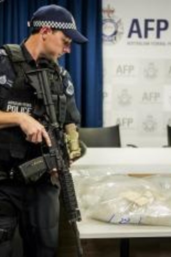 An armed police officer stands guard over one of the ACT's largest drug seizure of methamphetamine.