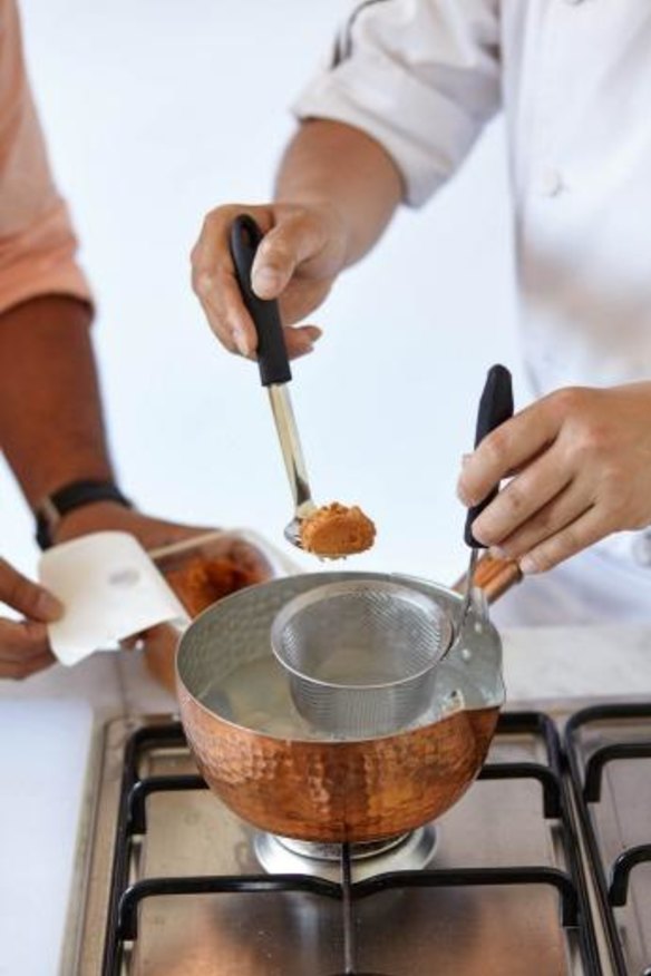 Dissolve the miso through a sieve or in the base of a ladle to remove any pieces of husk or uncrushed grain.