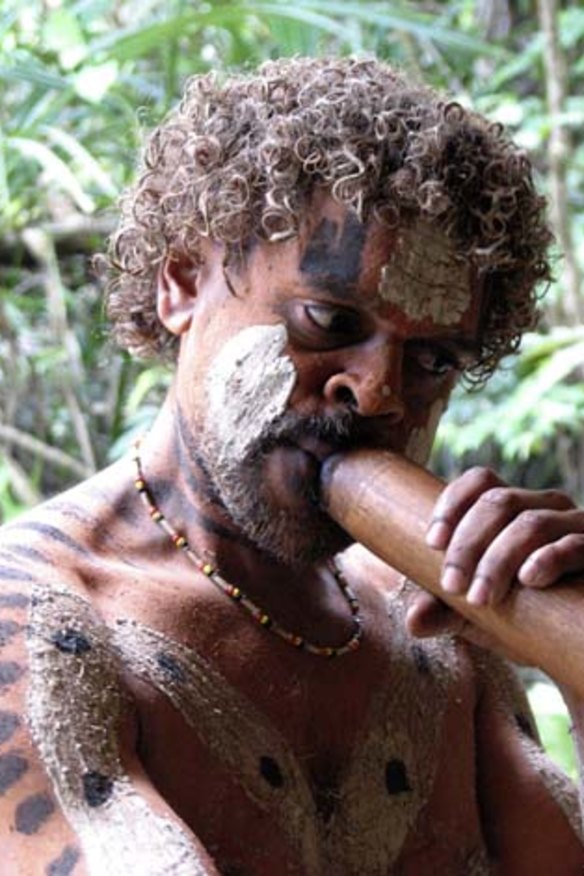 A man demonstrates his didgeridoo skills.