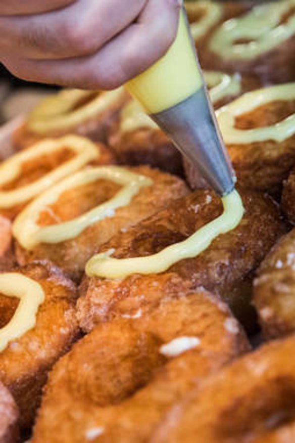 Glaze is piped onto cronuts at Dominique Ansel Bakery in New York City.