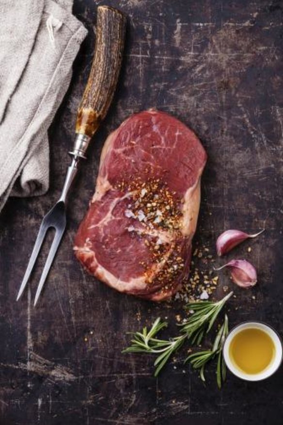 A raw ribeye steak ready for cooking.