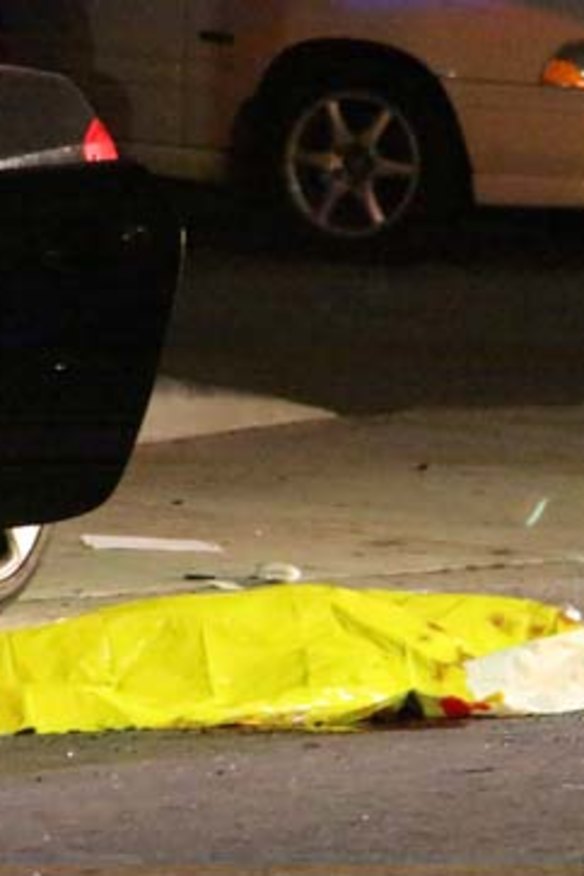 One of the nine crime scenes: A body is covered on the ground after a mass shooting near the campus of the University of California.