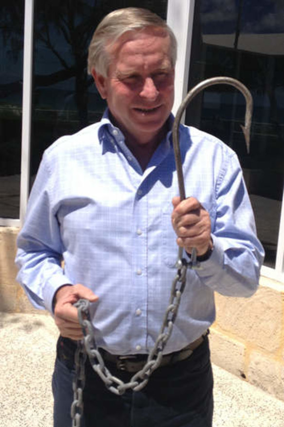 WA Premier Colin Barnett posing with a hook to be used to catch sharks off drum lines.