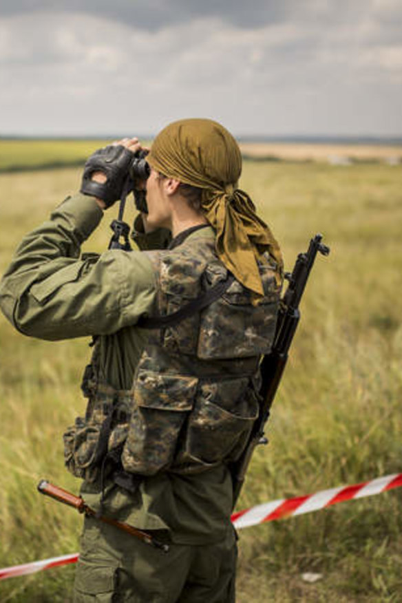 Russian separatists deny responsibility for the missile: A pro-Russia rebel surveys the area around the MH17 wreckage.