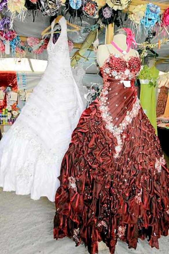 Wedding gowns hang in a covered stall in the Zaatari refugee camp.