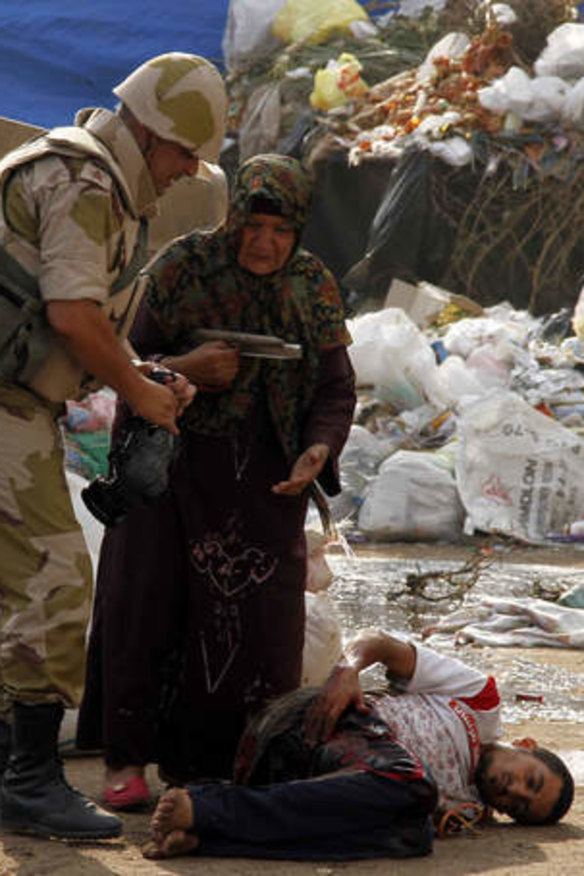 A soldier comes to assist her.