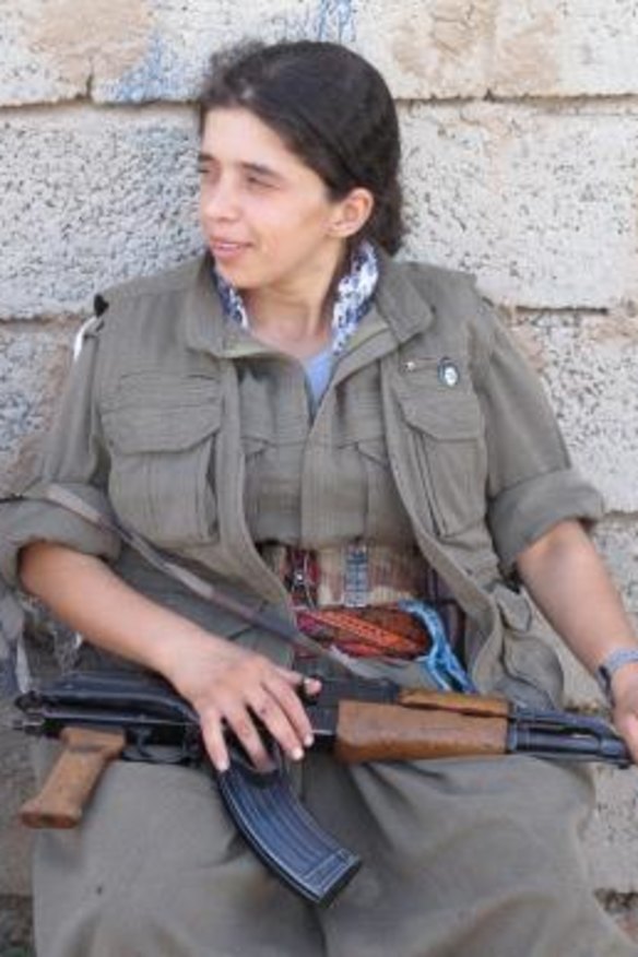A PKK fighter rests after a night on the frontline.