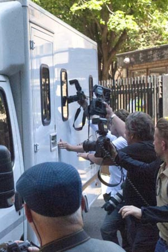 Leaving court: Rolf Harris is taken away after his sentencing.