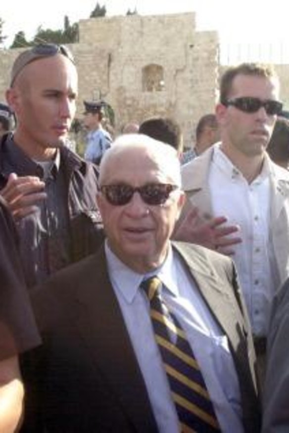 Comeback: Israeli security men and police surround Sharon during his controversial visit to the precincts of the al-Aqsa mosque in occupied East Jerusalem in September 2000. Within months he would be prime minister.   