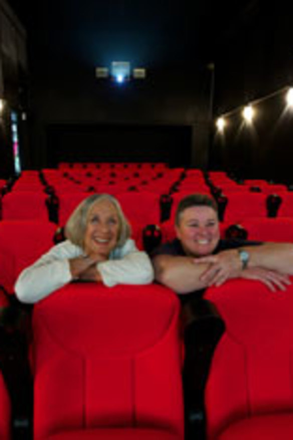 Loretta Little and Karen Hemming sit in the new theatre.
