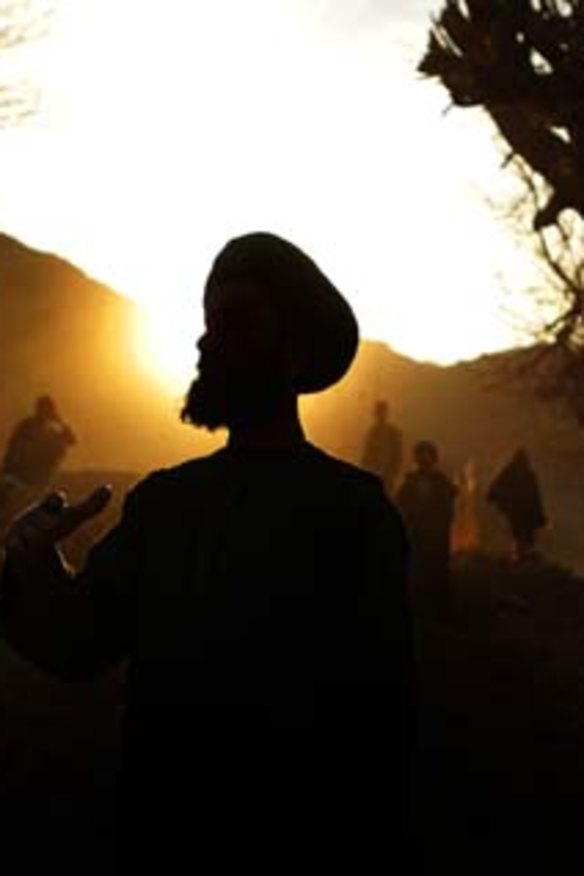 A group of men build a flood wall on the banks of the Saraw River in the Char Chino district.