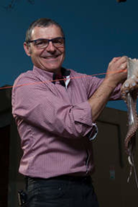 Peter Xynas of Albert Park Deli hangs an octopus on the clothesline, as learnt from his father.
