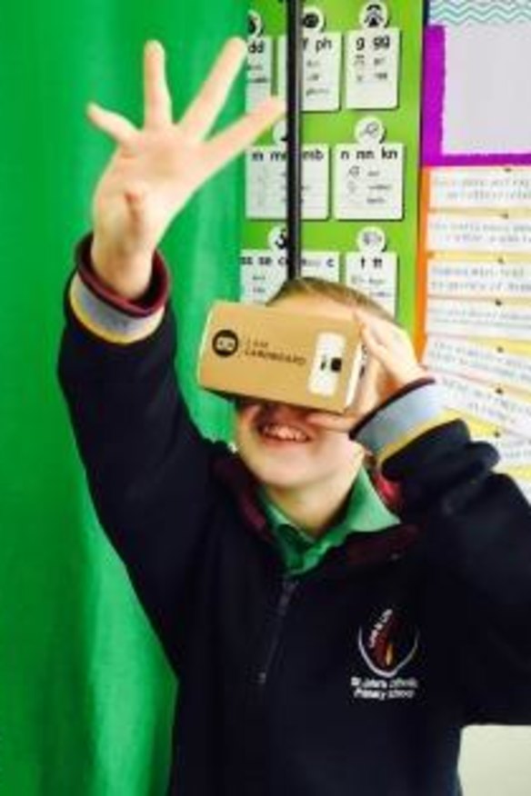 Teacher Sarah Anderson and one of her students with a Google Cardboard viewer. 