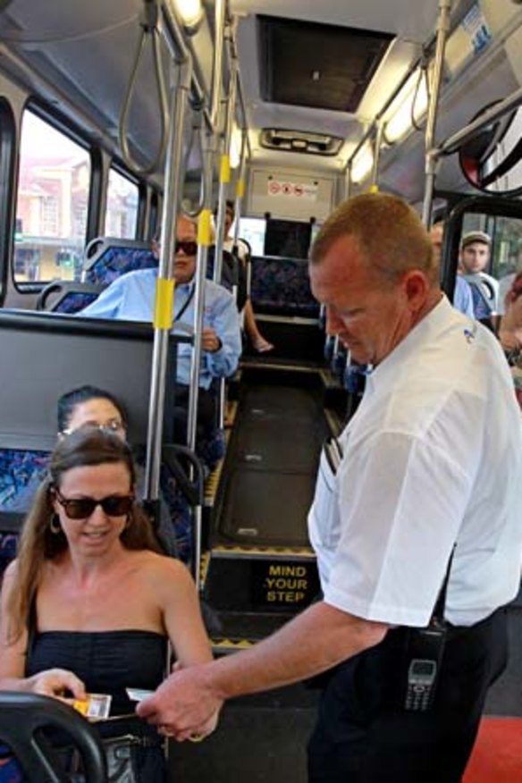 Just the ticket: Transport officer Arron Cutugno checks on bus passengers at Bondi Junction.