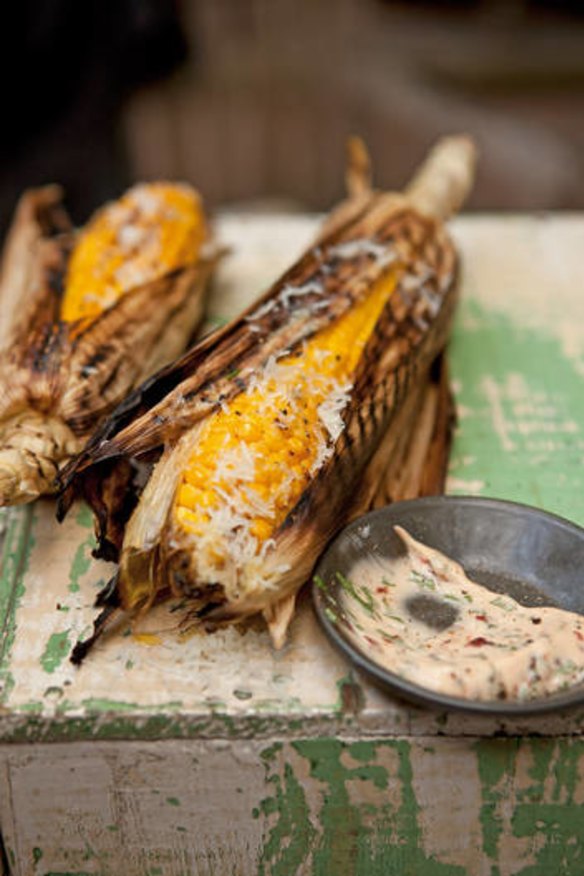 Grilled corn cobs in the husk.