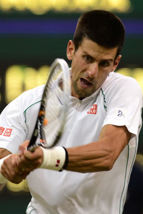 No, that's not a cheese ball he's hitting. Novak Djokovic hits a backhand on the court.