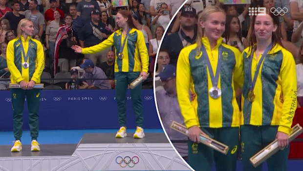 Gold medallist Mollie O'Callaghan invites silver medallist Ariarne Titmus to share the top step of the podium following the 200m freestyle final at Paris 2024.