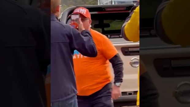 A One Nation volunteer in Farrer attempts to grab Opposition Defence spokesman James Paterson's phone.