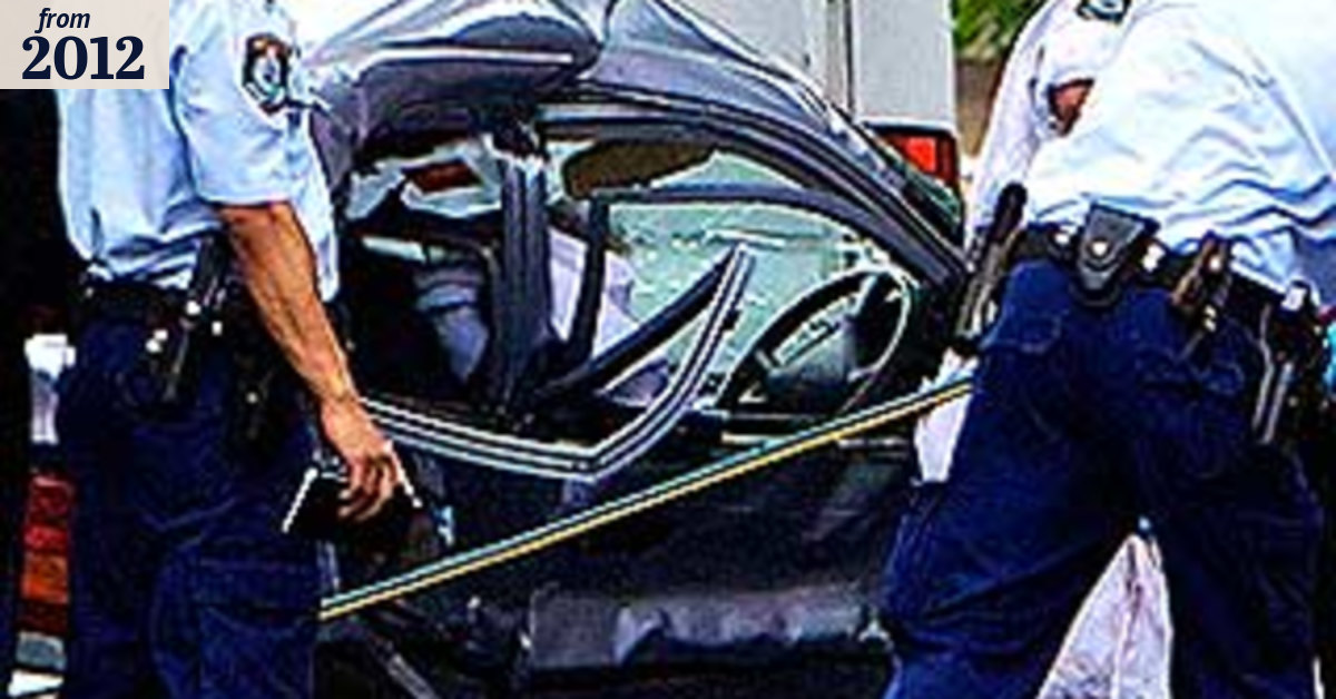 Woman killed in crash with police car on emergency call