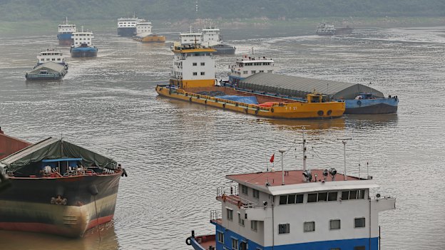 Cargo ships sail into Chongqing's free-trade port, connected to 13 rail lines.