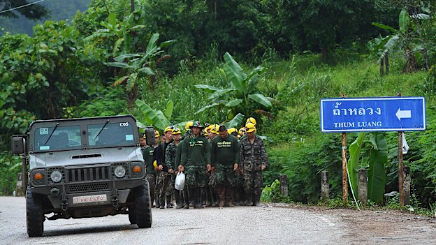 Thai army soldiers return from the base camp near Tham Luang cave.