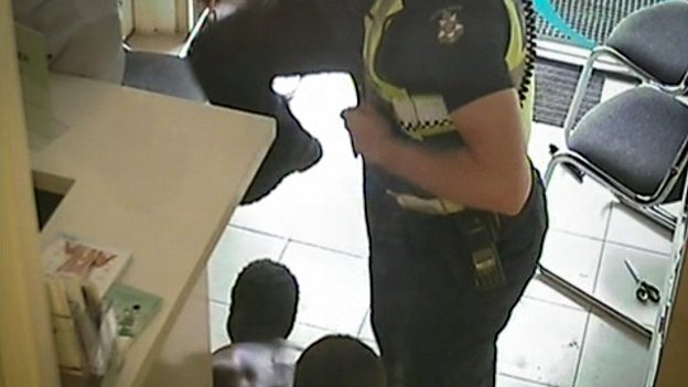 A still from CCTV footage of the arrest of a man in a Preston chemist.