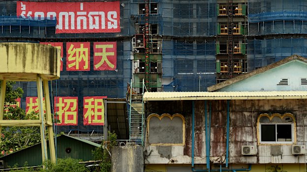 Towers in the Blue Bay complex rise up to dwarf Cambodian buildings on Independence Beach. The project includes a private beach. 