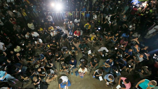 Thai media listen as Province Acting Governor Narongsak Osatanakorn speaks at a press conference. 