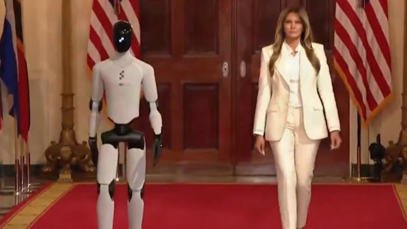 Melania Trump walks side by side with robot