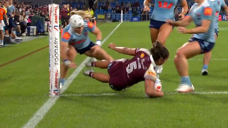 Peters dives over two Blues to score