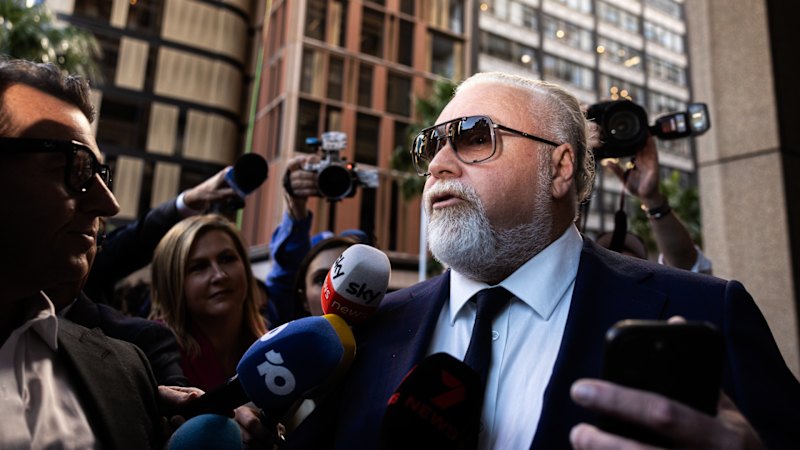 Kyle Sandilands arrives at court in Rolls-Royce