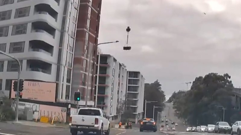 Construction workers narrowly avoid falling load
