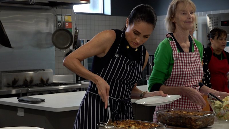 Meghan serves food for women at community service