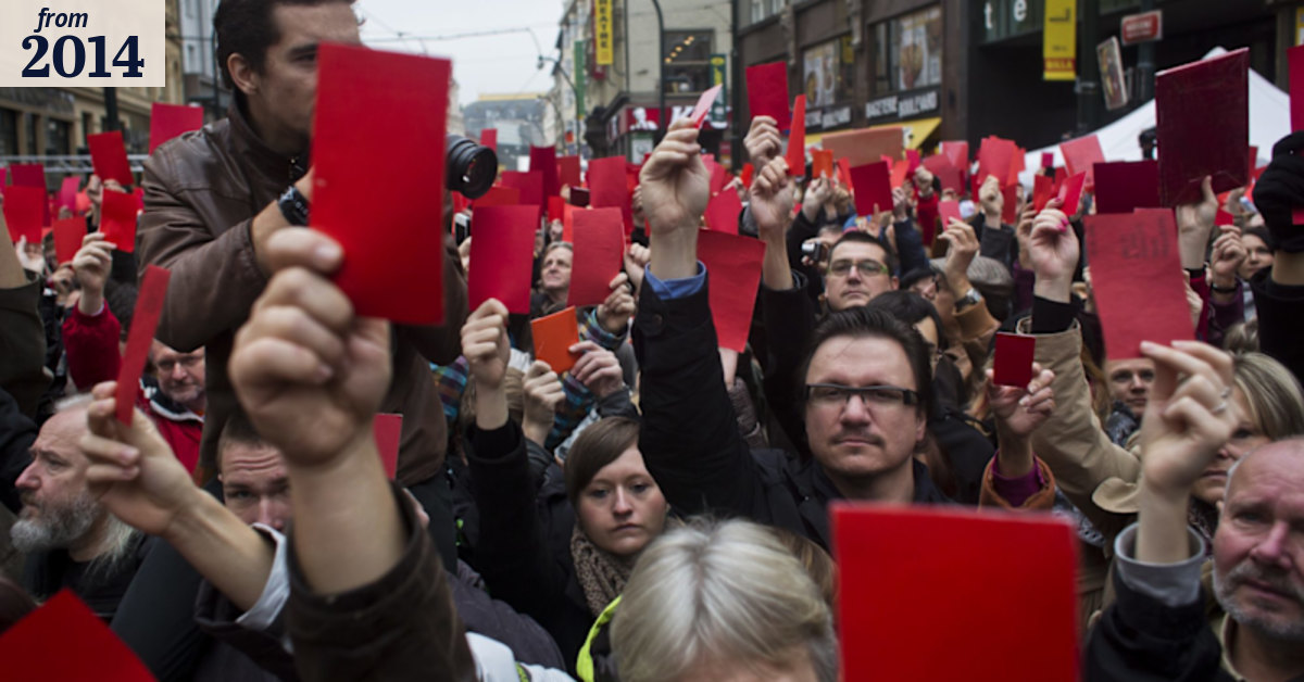Czechs wave red cards in protest, marking Velvet Revolution
