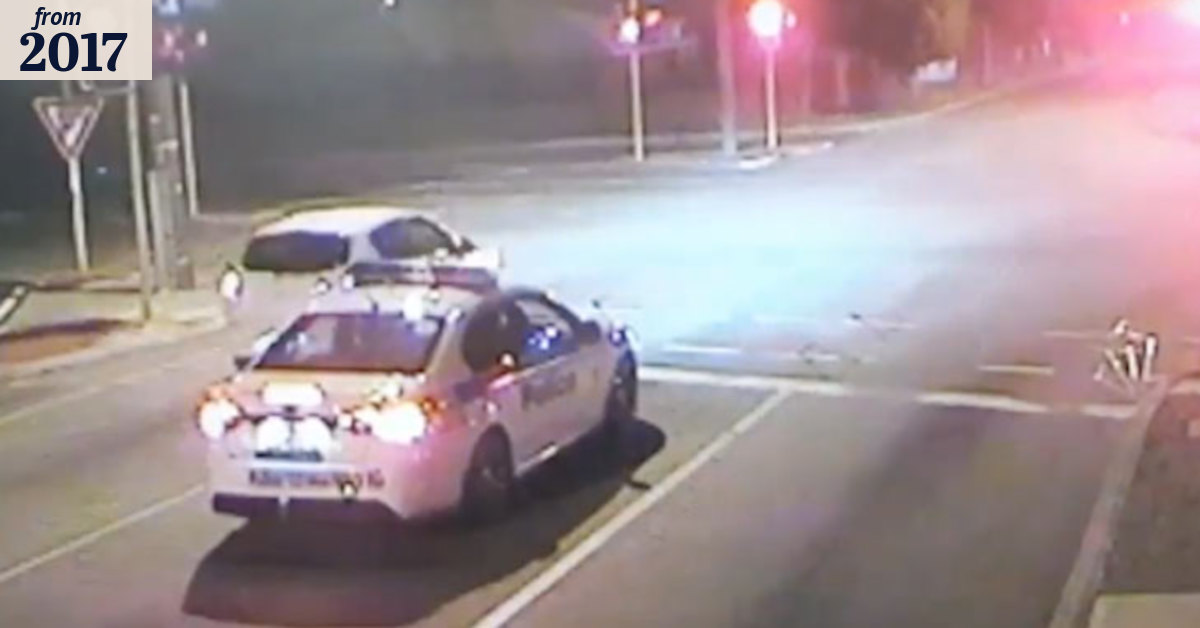Driver runs red light in front of police