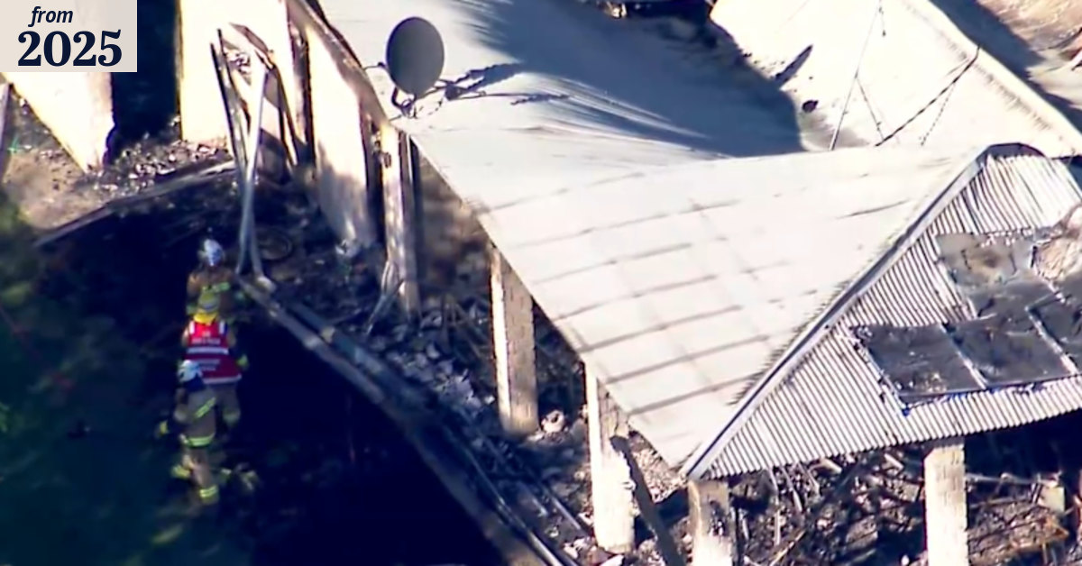 Woman dead, man in custody after house fire