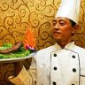 A cook poses with a plate of yak penis at the Guolizhuang Penis Restaurant in Beijing, China. 