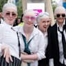 Thousands of "baldies" are swarming Australia's east and west coasts dressed as singer and rapper Pitbull for a tour they've waited 13 years for.