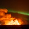 Stunning timelapse captures a volcano erupting during the Northern Lights display in Iceland.