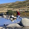 Higher calling ... a hiker crosses Snowy River.